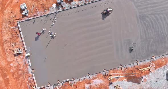 After Pouring Concrete on the Foundation Floor Workers are Polishing the Concrete with Concrete