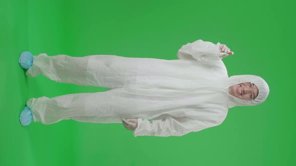 Full Body Of Asian Man Wear Uniform Ppe And Holding A Glass Of Test Tube In Green Screen Studio