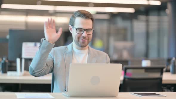 Casual Man Talking on Video Call on Laptop