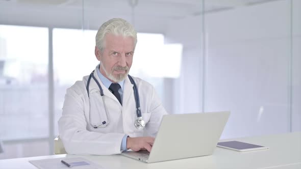 Thumbs Up By Old Senior Doctor in Clinic