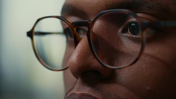 Closeup Portrait of African American Database Developer with Glasses Working Focused Looking at