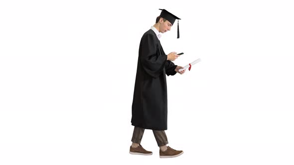 Graduation: Happy Student Walking and Texting on His Phone on White Background.