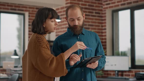 Business People Analyzing Information on Digital Tablet