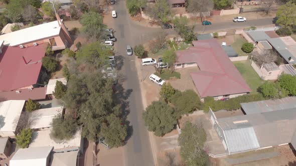 aerial shot following a car driving through a residential suburb