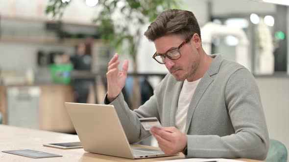 Successful Middle Aged Man Making Online Payment on Laptop