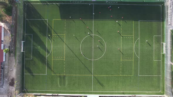 Two teams playing football top view. Children are playing football.