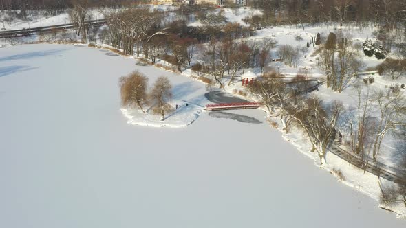 An Island on a Lake with a Bridge in the Winter Loshitsky Park