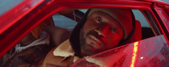 African American Man in Car and Posing for Camera