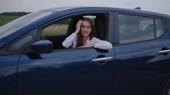 Young Woman Looks on the Beauty of the Nature and Smiles