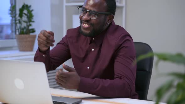 African Man Has Fun Talking on Video Meeting on Computer Spbas