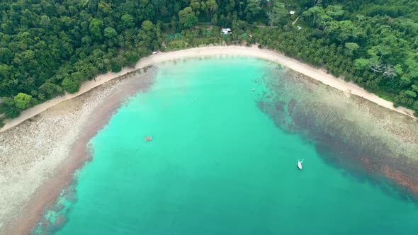 Aerial View of Tropical Sandy Beach in Bay with Blue Water. Seascape with Sea, Sand, Palm Trees. Top