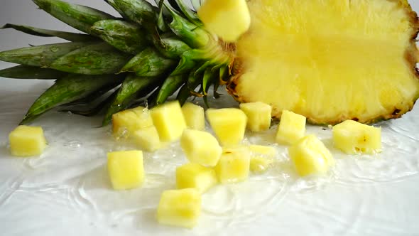 Falling juicy pieces of pineapple. Slow motion.