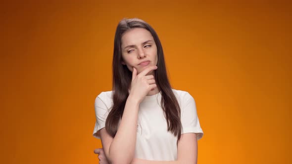 Blonde Woman Thinking Over Smart Idea Pondering Against Yellow Background