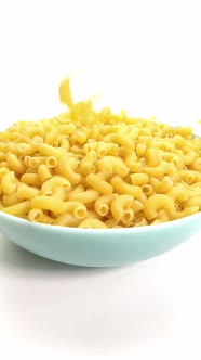 Macaroni of Hard Varieties Fall Into a Blue Dish, Slow-motion, Close-up
