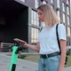 Woman scanning qr code on electric scooter, rental service app. - VideoHive Item for Sale