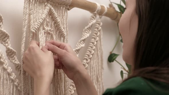 Woman Weaves Macrame on a Stick