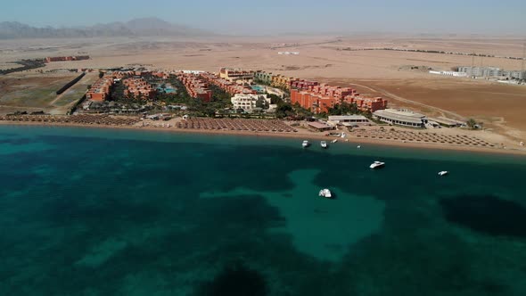 Beautiful sandy beach, azure transparent sea. People bathe in the Red Sea