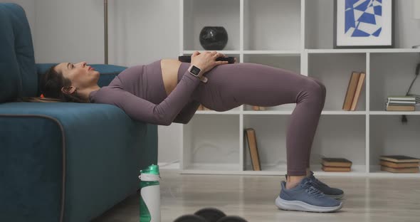 Sporty Young Lady Is Doing Exercise for Abdominal with Weight in Living Room Training at