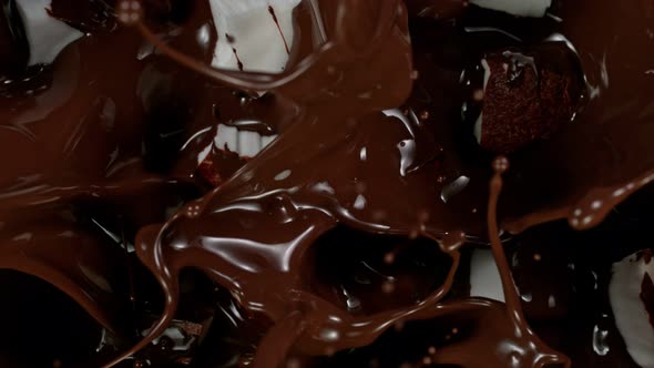 Super Slow Motion Shot of Coconut Pieces Falling Into Melted Chocolate at 1000 Fps
