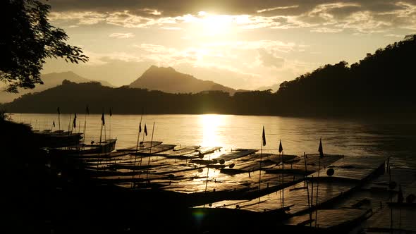 Sunset time lapse with Long-tail boats at the Mekong River 