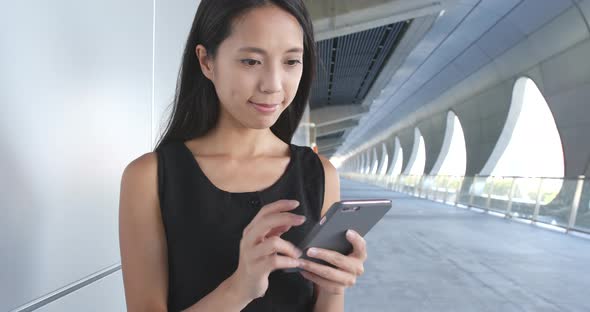 Woman working on mobile phone at outdoor 