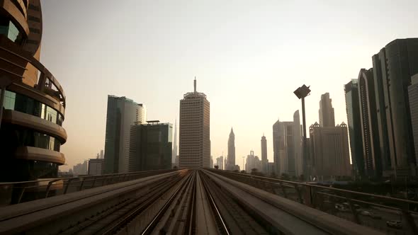 Metro Railway Train Track Moving between Cityscape Skyline Buildings