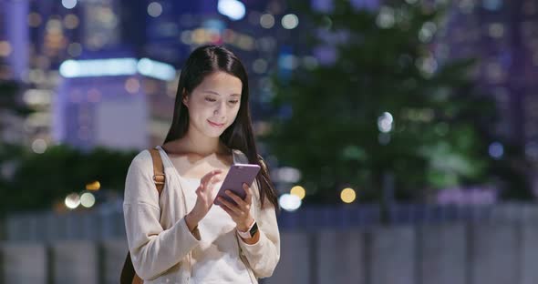 Woman use of smart phone in city