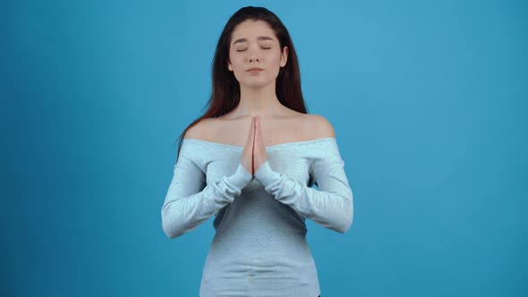 The Young Woman Puts Her Hands Together to Pray at the End She Smiles