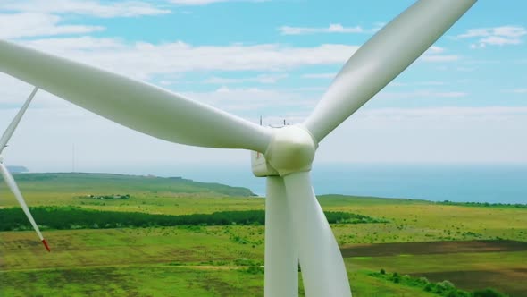 Wind Turbine Farm Generating Clean Renewable Energy In Green Agricultural Field Aerial Landscape