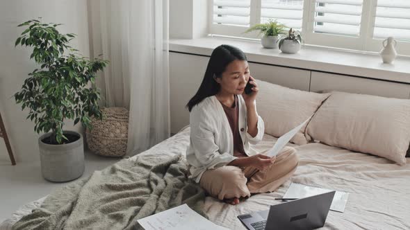 Businesswoman Working on Bed