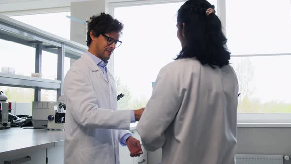 Scientists Shaking Hands in Laboratory