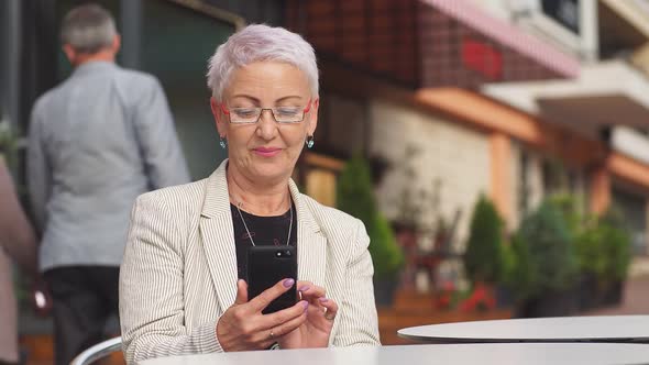 Portrait of Modern Stylish Lady Sitting in Street Cafe