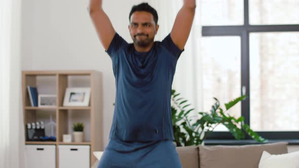 Indian Man Doing Jumping Jack Exercise at Home