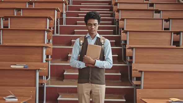 Insecure Mixed-Race Student in Eyeglasses Standing in Lecture Hall