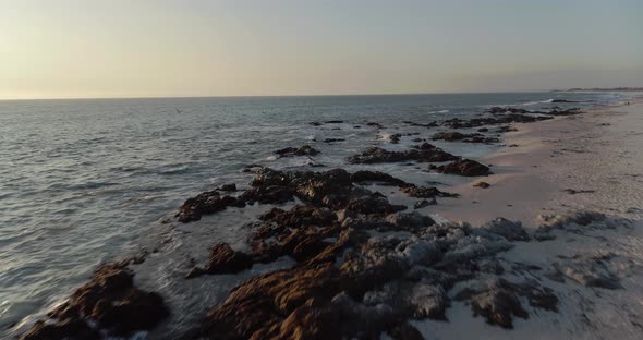 4k Drone Tracking shot of Atlantic Ocean and Beautiful Blouberg Coastline at Sunset