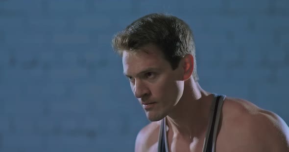 Intense Look of an Athlete During Training Breathing