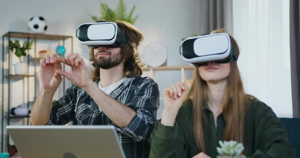 Young Man and Woman in Special 3d Glasses which Working on Virtual Screen