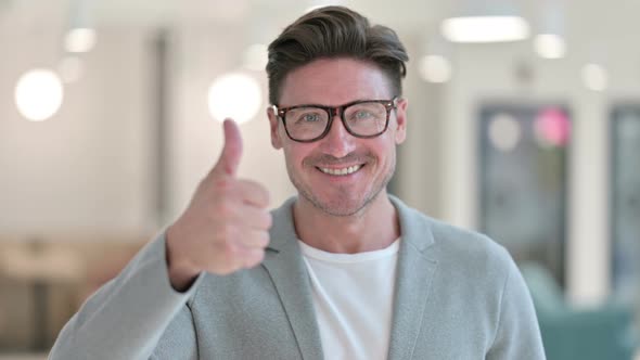 Portrait of Successful Middle Aged Man Showing Thumbs Up