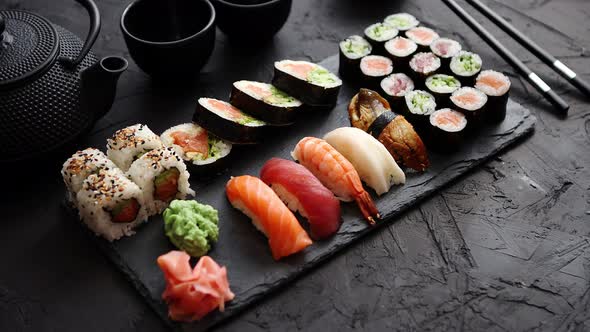 Sushi Rolls Set with Salmon and Tuna Fish Served on Black Stone Board