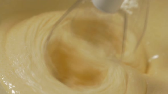 Close-up slow motion mixing muffin mixture with electric mixer FullHD 1080p video - Muffin mixture i