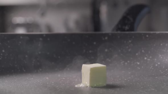 Falling of the One Piece of Butter Cube From Wood on Frying Pan