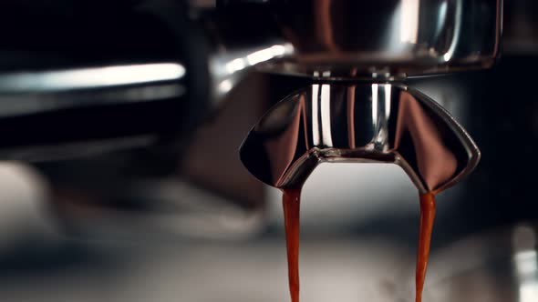 Super Slow Motion Detail Shot of Coffee Machine Pouring Espresso at 1000Fps