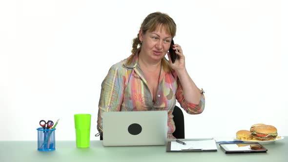 Cheerful Office Woman Talking on Phone Sitting at Her Workplace