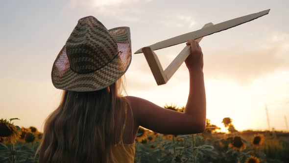 Silhouette Happy Girl at Sunset Wants to Astronaut Pilot