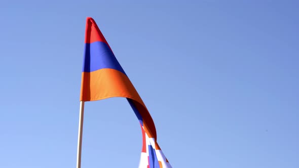 Artsakh flag on background blue sky. Nagorno Karabakh flag on sky.