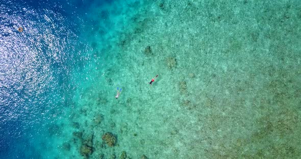 Beautiful fly over clean view of a sunshine white sandy paradise beach and aqua turquoise water back