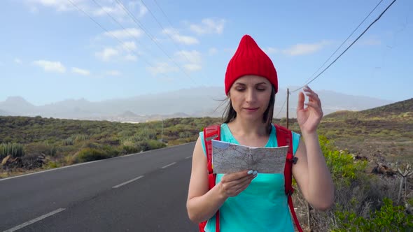 Traveler Woman Hitchhiking on a Sunny Road and Walking