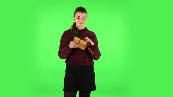 Girl Opens the Gift, Very Surprised and Gets Upset. Green Screen