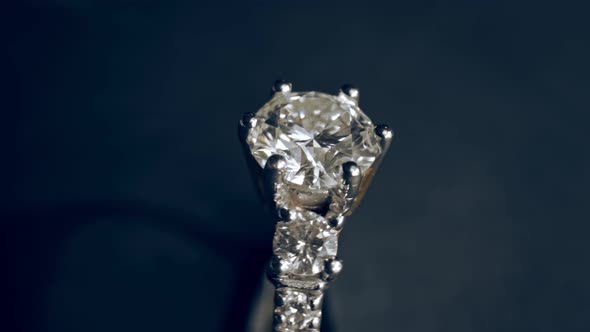 Extreme detailed of diamond ring close up shot while rotating on dark background