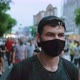 Portrait of Male Rebel Activist in Face Mask Marching in Protesting Riot Crowd - VideoHive Item for Sale